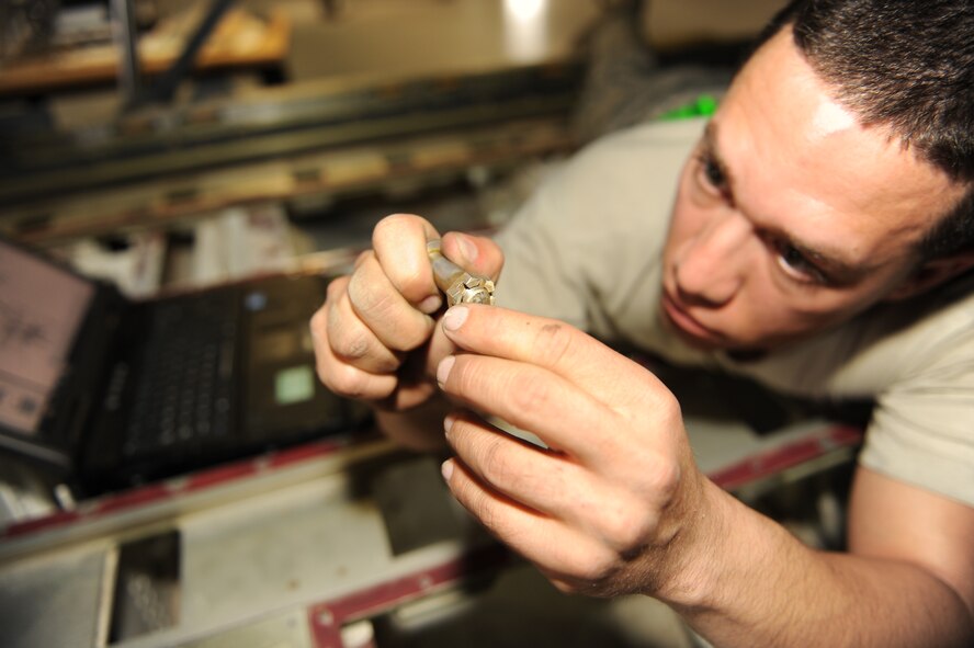 U.S. Air Force Tech. Sgt. Eric Albarran, 317th Maintenance Squadron repair and reclamation lead technician, inspects a screw while working on the cargo ramp actuator on a C-130J Oct. 30, 2013, at Dyess Air Force Base, Texas. Airmen must ensure each part is thoroughly inspected before reassembly. (U.S. Air Force photo by Airman 1st Class Kedesha Pennant/Released)

