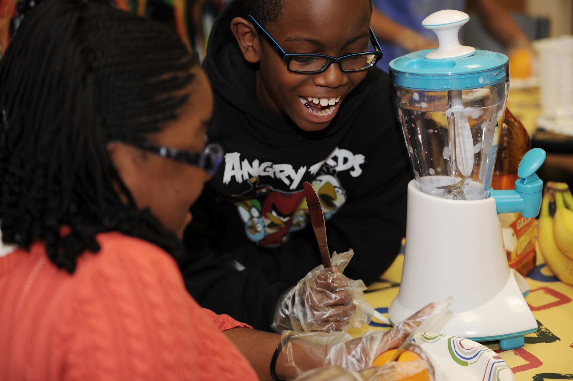 Two Joint Base Langley-Eustis children create fruit smoothies during the Joint Base Langley-Eustis Youth Program’s Triple Play event at the Bethel Manor Youth Center, Yorktown, Va., Nov. 5, 2013. Creating smoothies was part of Triple Play’s “mind” aspect, which concentrated on incorporating healthy living and active learning into the everyday lives of participants. (U.S. Air Force photo by Staff Sgt. Jarad A. Denton/Released)