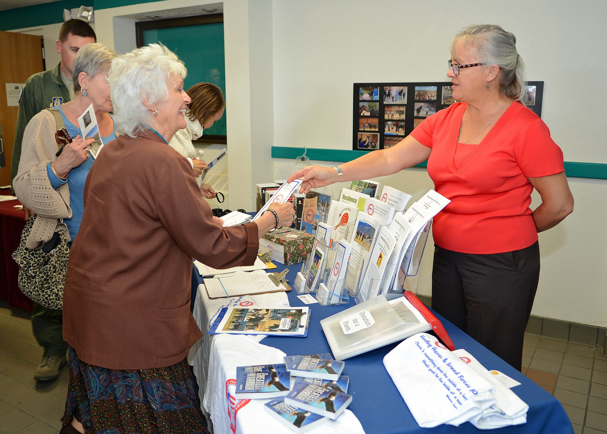 Charisse Rudolph (right) from the Healing Horses and Armed Forces organization was also in attendance to hand out pamphlets to the Edwards community after the Wingman Day event at the Base Theater Nov. 4. Rudolph discussed the free equine assisted learning programs they provide for veterans, active duty servicemembers and their families. (U.S. Air Force photo by Jet Fabara)