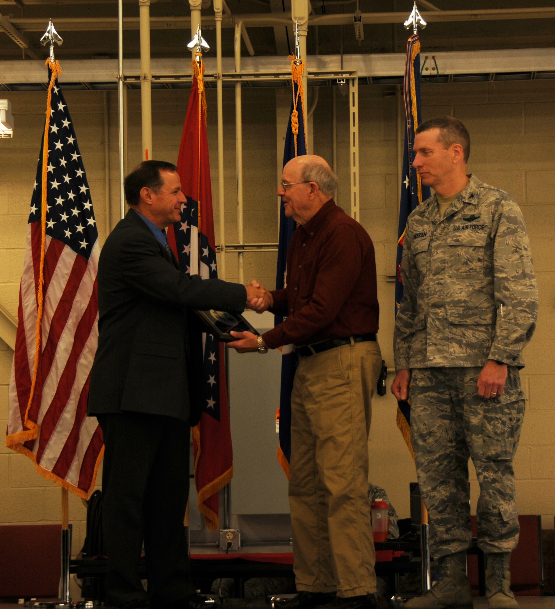 Lt. Col. (ret.) Kenny Moix, executive director of the National Guard Association of Arkansas, left, and Col. Mark Anderson, 188th Fighter Wing commander, right, present Dr. Jerry Stewart, president of the 188th Fighter wing/Fort Chaffee Community Council, with the National Guard Association of the United States’ Patrick Henry Award at the 188th Fighter Wing's 60th anniversary celebration Nov. 2, 2013. (U.S. Air National Guard photo by Senior Airman John Hillier/188th Fighter Wing Public Affairs)