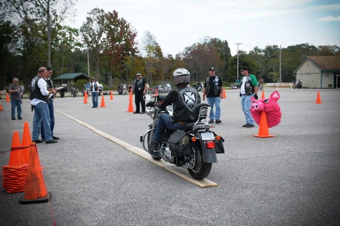 Marvin McDonald and his daughter of the Green Knights Military Motorcycle Club, representing military and DoD motorcyclists, rides their motorcycle through an obstacle course during the 2013 Knights of the Round Table competition Oct. 20, 2103, in Charleston, S.C. The Green Knights won the coveted knight's scepter and will host next year's competition. (Courtesy photo)