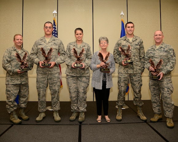 (Left) Col. Jeffrey DeVore, Joint Base Charleston commander, and (Right) Chief Master Sgt. Al Hannon, 628 Air Base Wing command chief, stand with the 628th ABW 3rd Quarter Award Winners during October’s monthly promotion ceremony and combined Quarterly Awards ceremony Oct 31, 2013, at Joint Base Charleston – Air Base, S.C. (Left to Right), Senior Airman Scott Zawacki, Airman of the Quarter, Master Sgt. Sarah Swift, Senior Noncommissioned Officer of the Quarter, Cheryl Bennett, Civilian of the Quarter Category II, and 2nd Lt. Nicholas Barrett, Junior Company Grade Officer of the Quarter. Not pictured here is Capt. Elaine Christian, Senior Company Grade Officer of the Quarter, Tech. Sgt. Toriano Banks, Noncommissioned Officer of the Quarter, Tech. Sgt. Dustin Livingston, Honor Guard of the Quarter, and Elizabeth Volkman, Civilian of the Quarter Category I. (U.S. Air Force photo/ Tech. Sgt. Rasheen Douglas)