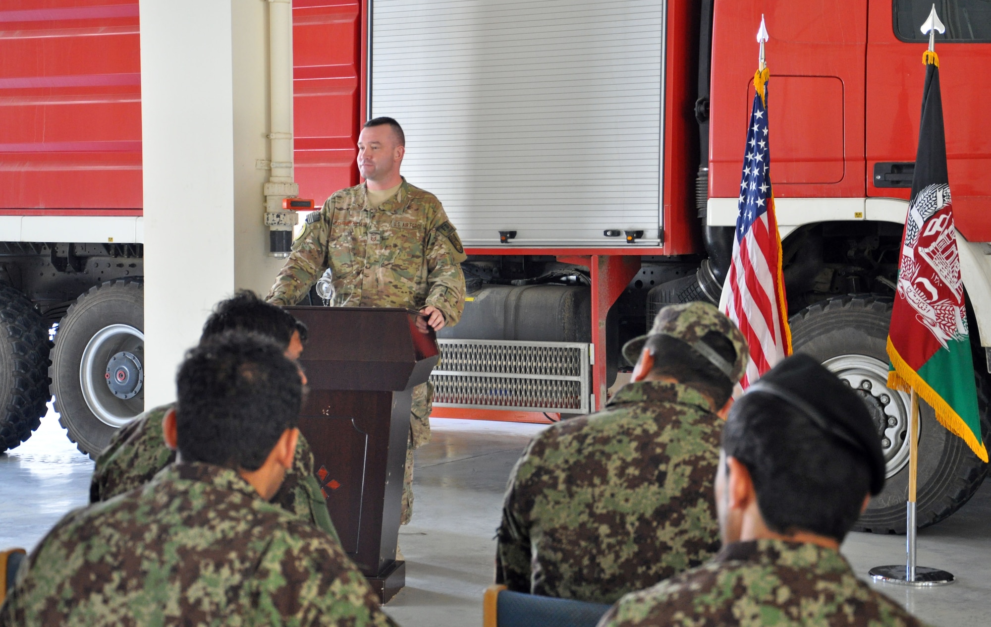 Master Sgt. Jeffery Hackworth addresses graduates of the first Afghan Fire Instructor Course during a ceremony Oct. 31 at Kabul International Airport, Afghanistan. The five-day class graduated 13 Afghan Air Force and Afghan National Army firefighters as certified instructors. The graduates can now certify additional firefighters at their home fire stations. Hackworth is the NATO Air Training Command-Afghanistan fire adviser. (U.S. Air Force photo/Capt. Anastasia Wasem)

