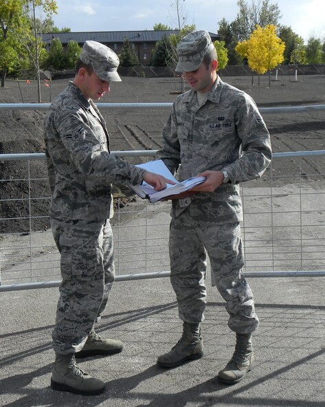 Airman 1st Class Wesley Bybel (left) and Airman 1st Class Garrett Murray, 319th Contracting Flight contract specialists, ensure a contractor is fulfilling the obligations of a contract Sept. 21, 2012, on Grand Forks Air Force Base, N.D. Bybel is the 319th Air Base Wing’s Warrior of the Week for the first week of November 2013. (Courtesy photo)
