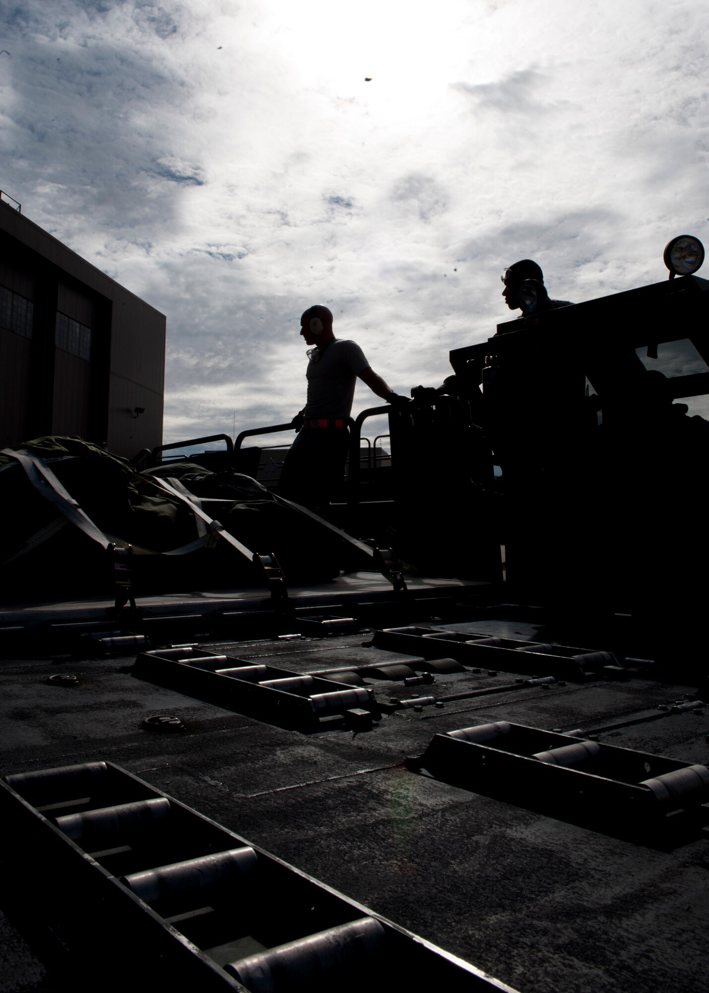 Airmen from the 71st Aerial Port Squadron exchange parts of a K loader during a training mission at Langley Air Force Base, Va., Nov. 2, 2013. The 71st APS is an Air Force Reserve unit that provides the military logistical functions of processing personnel and cargo, rigging for airdrop and packing parachutes. (U.S. Air Force photo by Staff Sgt. John D. Strong II/Released)