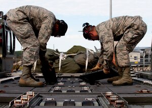 Airmen from the 71st Aerial Port Squadron exchange parts of a K loader during a training mission at Langley Air Force Base, Va., Nov. 2, 2013. The 71st APS is an Air Force Reserve unit that provides the military logistical functions of processing personnel and cargo, rigging for airdrop and packing parachutes. (U.S. Air Force photo by Staff Sgt. John D. Strong II/Released)