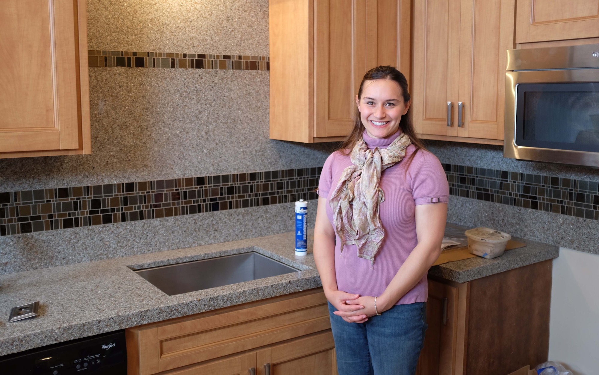 Staff Sgt. Naomi Bouska, 934th Force Support Squadron, stands in her newly remodeled kitchen. The work was performed at no charge in a show of support for military members by a privately-owned company.  The transformation will Air on WCCO TV in Minneapolis at 5:30 a.m. Nov. 9.  (Air Force Photo/Paul Zadach)
