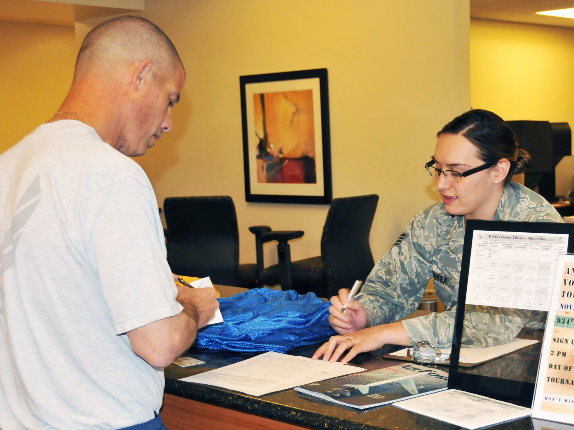 Staff Sgt. Naomi Bouska, 934th Force Support Squadron, assists an Airman with Fit to Fight documentation at the Fitness Center Nov. 3.  (Air Force Photo/Paul Zadach)