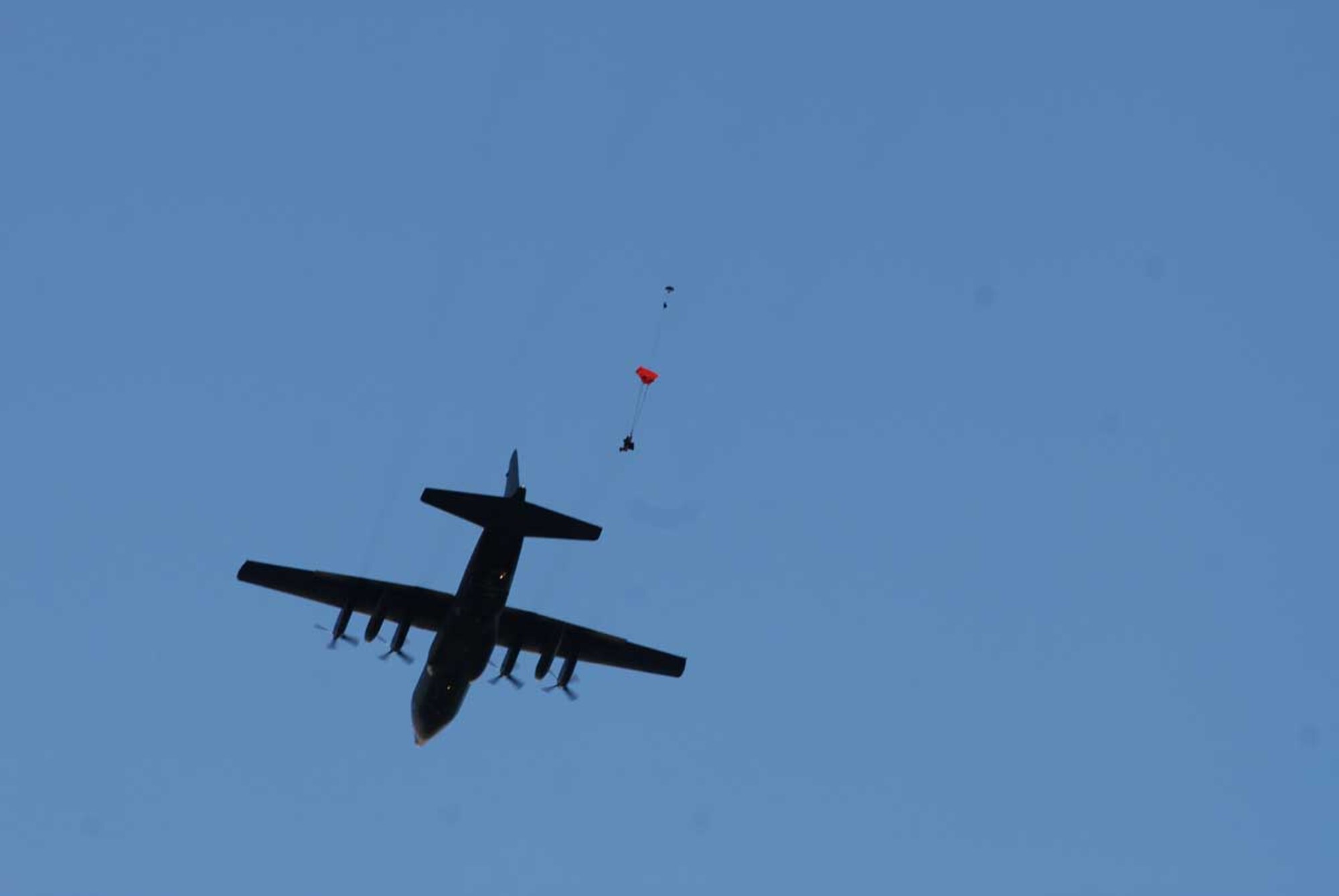 A Canadian Search and Rescue technician jumps from a plane over the Donnelly drop zone Oct. 30. The SAR Tech is part of the Joint Task Force-Alaska, Alaska National Guard, U.S. Army Alaska, Canadian Joint Operations Command, Arctic Search and Rescue Exercise held here and at Joint Base Elmendorf-Richardson. Canadian and U.S. Search and Rescue assets jumped into the simulated crash site and immediately began stabilizing and providing treatment to the wounded until support was available to transport the wounded to a medical treatment facility. This exercise aimed to increase the collective interoperability between the U.S. and Canada. (Photo by U.S. Army public affairs)