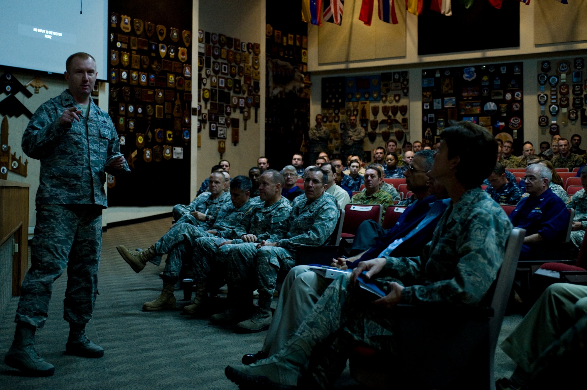 Cyber Flag 14-1 participants listen to a briefing in the Red Flag building Nov. 5, 2013, at Nellis Air Force Base, Nev. Cyber Flag is a joint cyberspace training exercise designed to provide realistic training opportunities in a virtual environment for cyber components and organizations throughout the government. (U.S. Air Force photo by Airman 1st Class Christopher Tam)