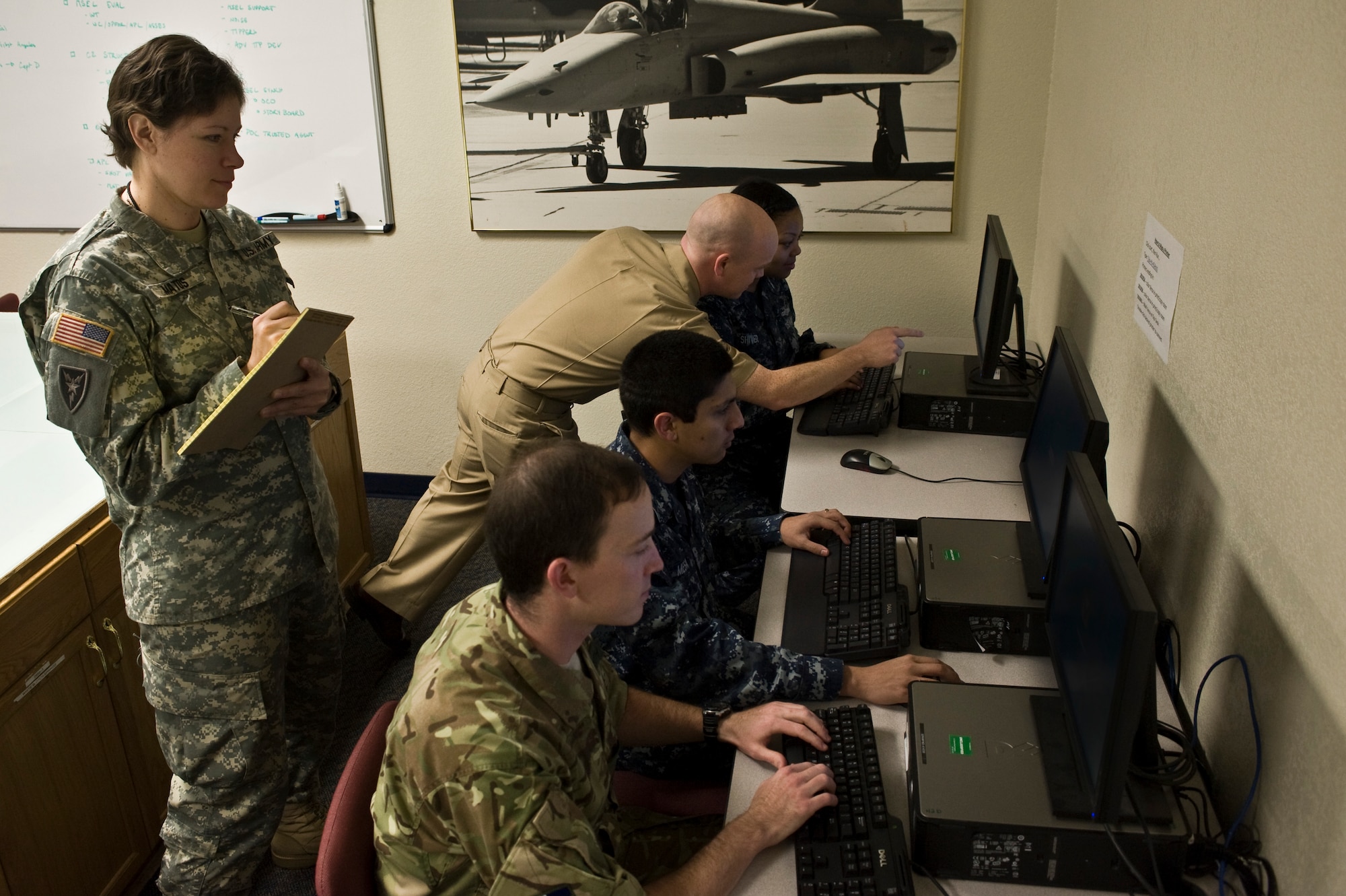 Cyber Flag 14-1 participants analyze an exercise scenario in the Red Flag building Nov. 5, 2013, at Nellis Air Force Base, Nev. Cyber Flag strategically focuses on exercising the command's mission of operating and defending the Department of Defense networks across the full spectrum of operations against a realistic adversary in a virtual environment. (U.S. Air Force photo by Airman 1st Class Christopher Tam)