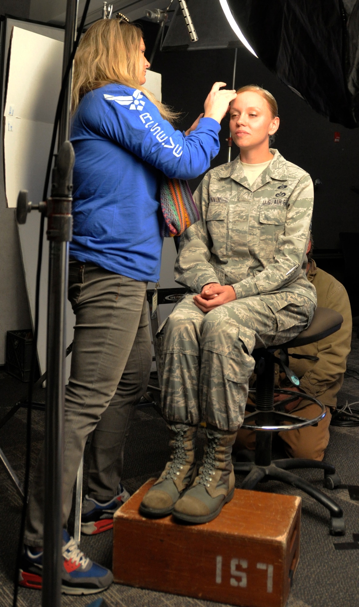 Master Sgt. Stephanie Bonnin has her hair fixed by a member of the Las Vegas advertising firm Blaine-Warren Nov. 4 at Peterson Air Force Base, Colo. The firm was in Colorado Springs to interview Airmen from the 302nd Airlift Wing and the 310th Space Wing at Schriever AFB, Colo. and to shoot background video for their upcoming public service announcement. The PSA will be used as a recruiting tool for the Air Force Reserve Command. Bonnin is an emergency management program specialist for the 302nd Civil Engineer Squadron. (U.S. Air Force photo/Master Sgt. Daniel Butterfield)
