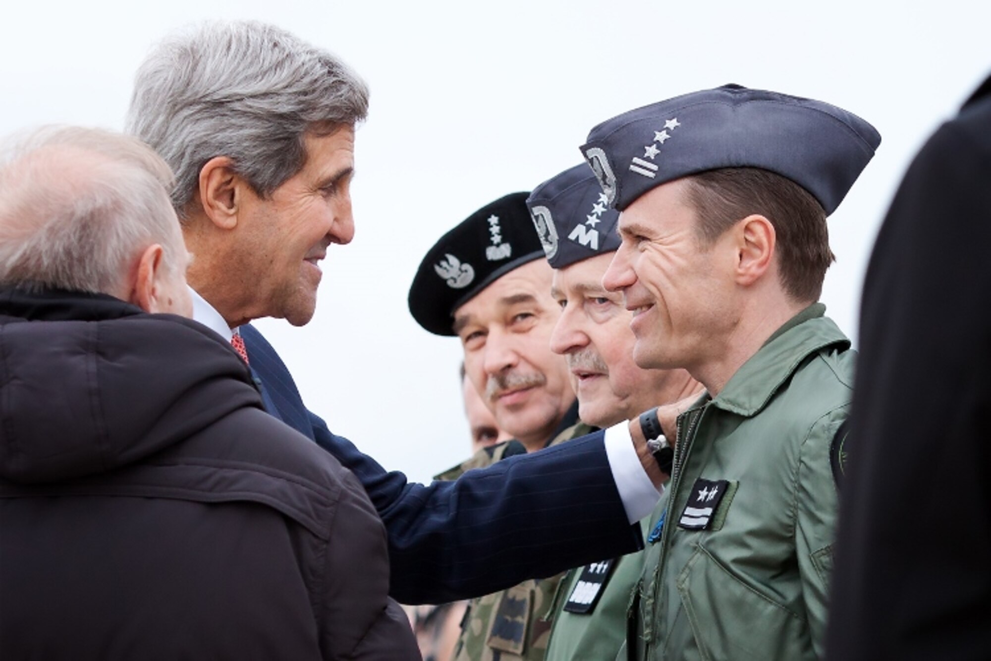 LASK AIR BASE, Poland -- U.S. Secretary of State John Kerry greets Polish air force members during a visit to Detachment 1, 52nd Operations Group, Nov. 5, 2013. The Av-Det is part of the  increased cooperation effort between U.S. and Polish air forces to enhance allied air power. (Photo by Polish Warrant Officer Class 2 Rafał Olejniczak/Released)