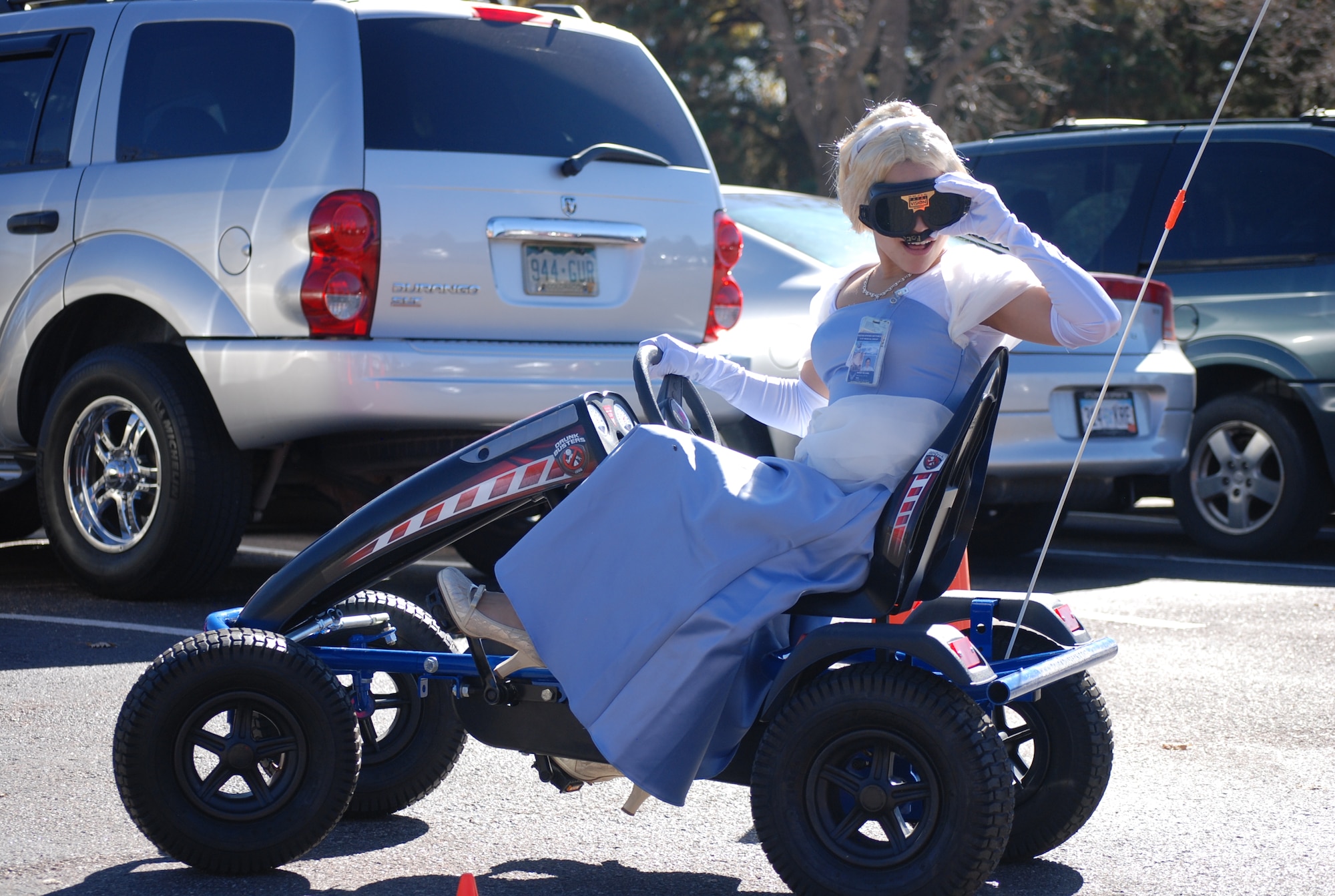 PETERSON AIR FORCE BASE, Colo. – Senior Airman Brandy Williams, 21st Medical Group, takes a turn using a drunk-driving simulator Oct. 31 at the 21st MDG Fall Outreach. Airmen and their families took part in spooky and educational festivities at the third annual outreach hosted by the 21st MDG, where kids took part in activities including face-painting, learning about germs using a black light and burning energy in a bounce house while parents had access to a number of booths setup by local organizations, all with the goal of promoting healthy living. (U.S. Air Force photo/Michael Golembesky)