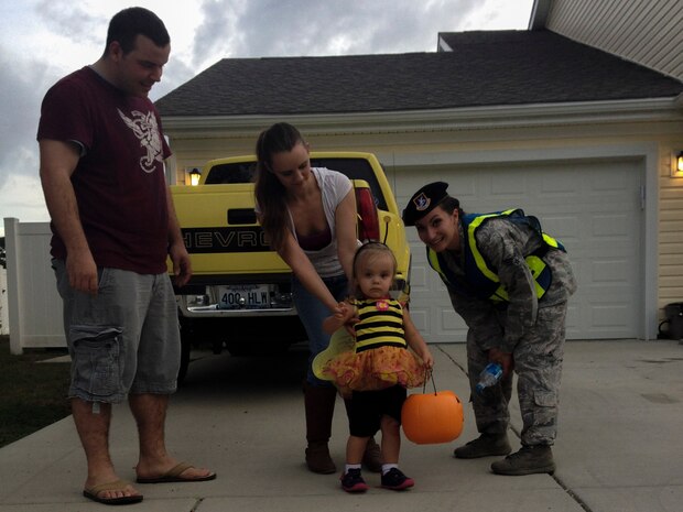 Airmen and their families trick or treat on Halloween, Oct. 31, 2013, at Joint Base Charleston – Air Base, S.C. The 628th Security Forces members and volunteers walked the streets of base housing while families were trick or treating to add extra security. (U.S. Air Force photo/ Airman 1st Class Chacarra Neal)