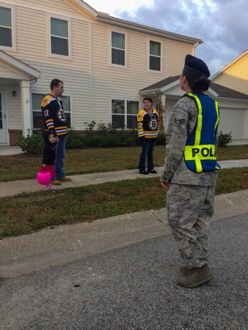 Airmen and their families trick or treat on Halloween, Oct. 31, 2013, at Joint Base Charleston – Air Base, S.C. The 628th Security Forces members and volunteers walked the streets of base housing while families were trick or treating to add extra security. (U.S. Air Force photo/ Airman 1st Class Chacarra Neal)