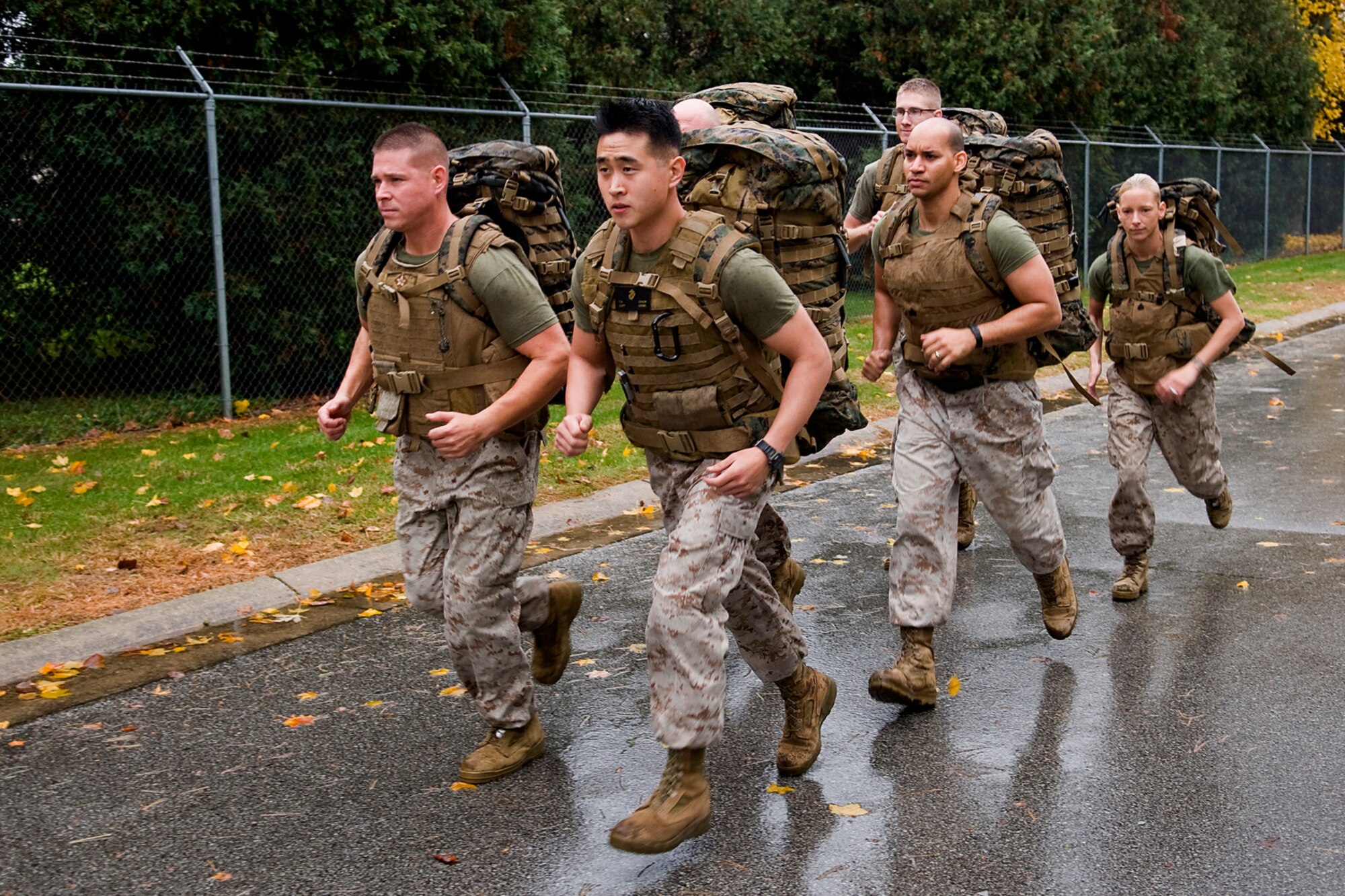 U.S. Marine Corps 1st Sgt. Greg Zieba, front left, and Capt. Timothy Chun, front right, lead Marines from Detachment One, Communication Company, Combat Logistics Regiment 45, 4th Marine Logistics Group on a ruck march during a 'Grissom Ghouls 5K' at Grissom Air Reserve Base, Ind., Oct. 31, 2013. While many of the run's participants dressed up in costumes, the Marines donned the heavy packs as they successfully accomplished the race. (U.S. Air Force photo/Tech. Sgt. Mark R. W. Orders-Woempner) 
