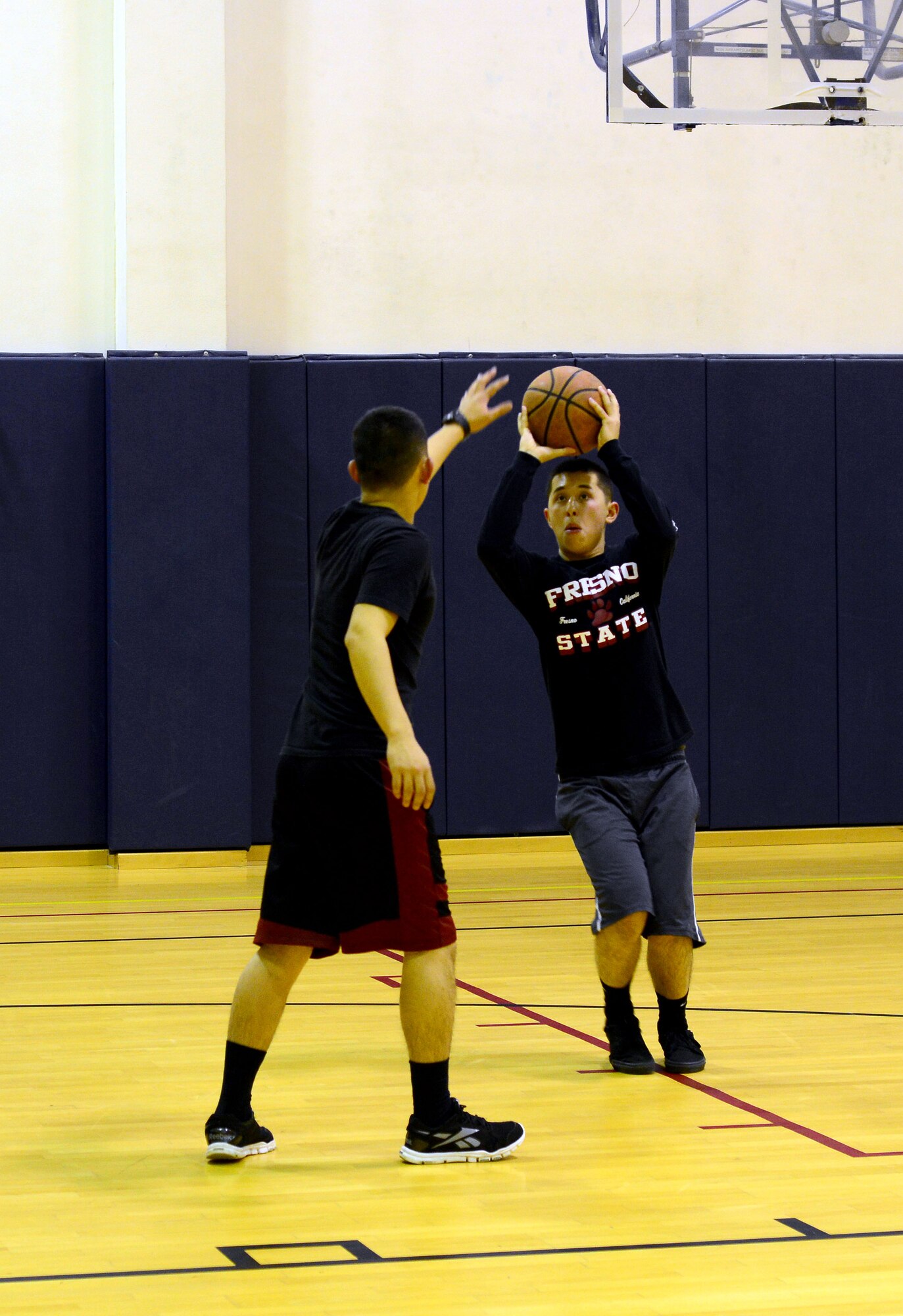 Airmen 1st Class Ja and Woo Lee, 20 year-old identical twins from Fresno, Calif., play basketball, Nov. 5, 2013, at Aviano Air Base, Italy. The brothers not only enlisted together, but completed basic and technical training and are both now assigned to Aviano. Both are defenders with the 31st Security Forces Squadron. (U.S. Air Force photo/Senior Airman Michael Battles)