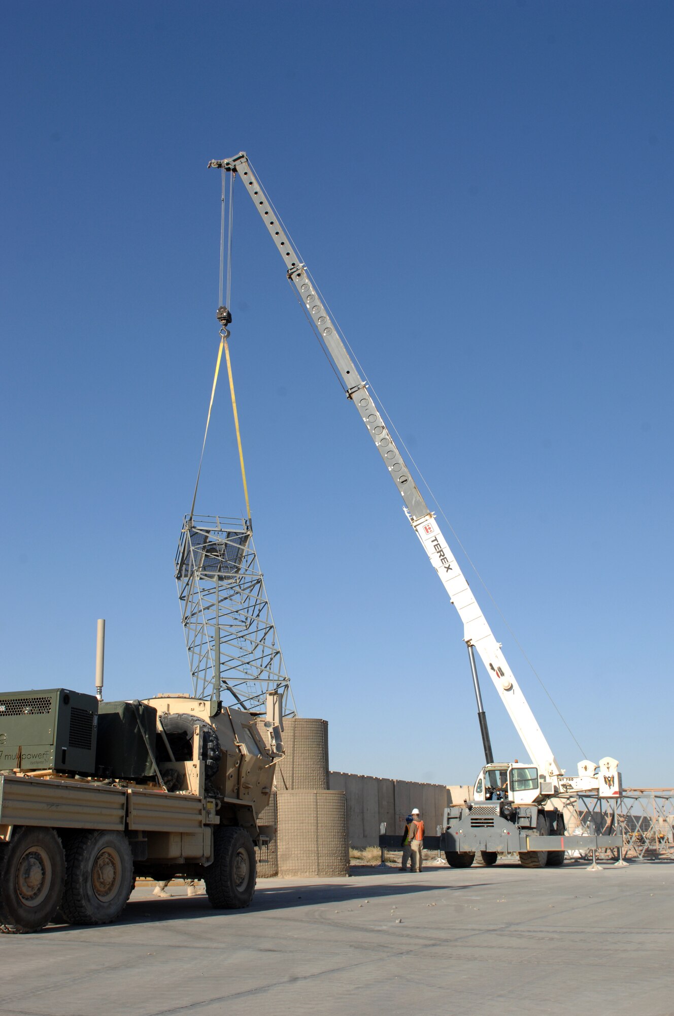 Members of Dyncorp Intl. use a crane to remove a tower from the Golf ramp with coordination from the 451st Expeditionary Civil Engineer Squadron at Kandahar Airfield, Afghanistan, Oct. 31, 2013. The team effort to remove key equipment from the Golf ramp included 45 volunteers from the Air Expeditionary Wing with help from the 955th Engineer Company/489th Engineer Battalion. Golf ramp is one of the first sections of the airfield here to be removed as part of the retrograde. (U.S. Air Force photo by Senior Airman Jack Sanders)