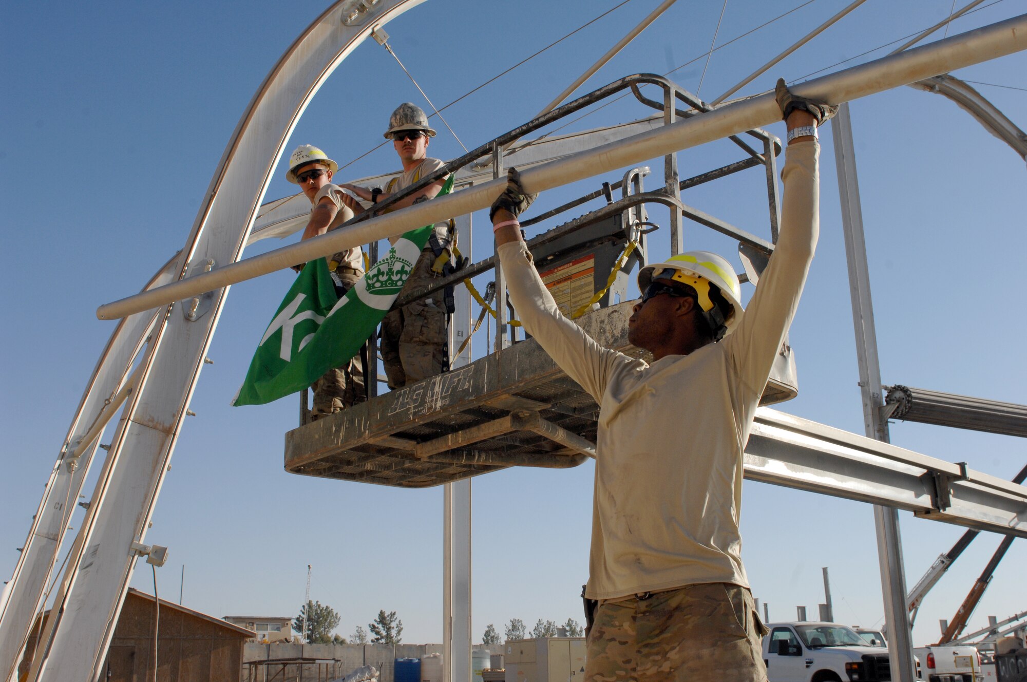 Airmen from the 577th Expeditionary Civil Engineer Squadron PRIME BEEF work to tear down parts of a clam shell hangar at Golf ramp on Kandahar Airfield, Afghanistan, Oct. 31, 2013. The Golf ramp is one of the first sections of the airfield here to be removed as part of the retrograde. (U.S. Air Force photo by Senior Airman Jack Sanders)