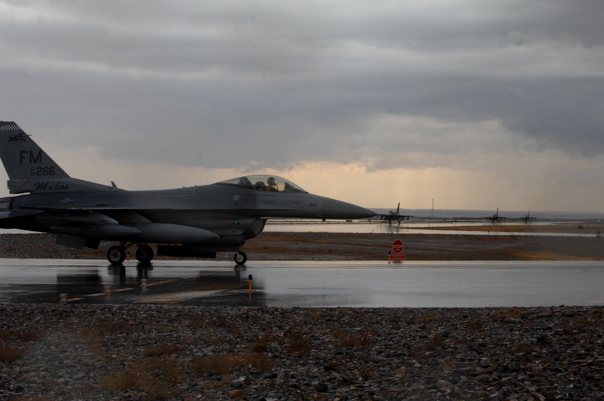 F-16 Fighting Falcons taxi down the runway at Kandahar Airfield, Afghanistan, Nov. 5, 2013. The aircraft are part of the changeover between the 457th Fighter Squadron from Carswell, Texas, and the 138th Fighter Squadron from Tulsa, Okla. Nov. 5, 2013. (U.S. Air Force photo by Senior Airman Jack Sanders)