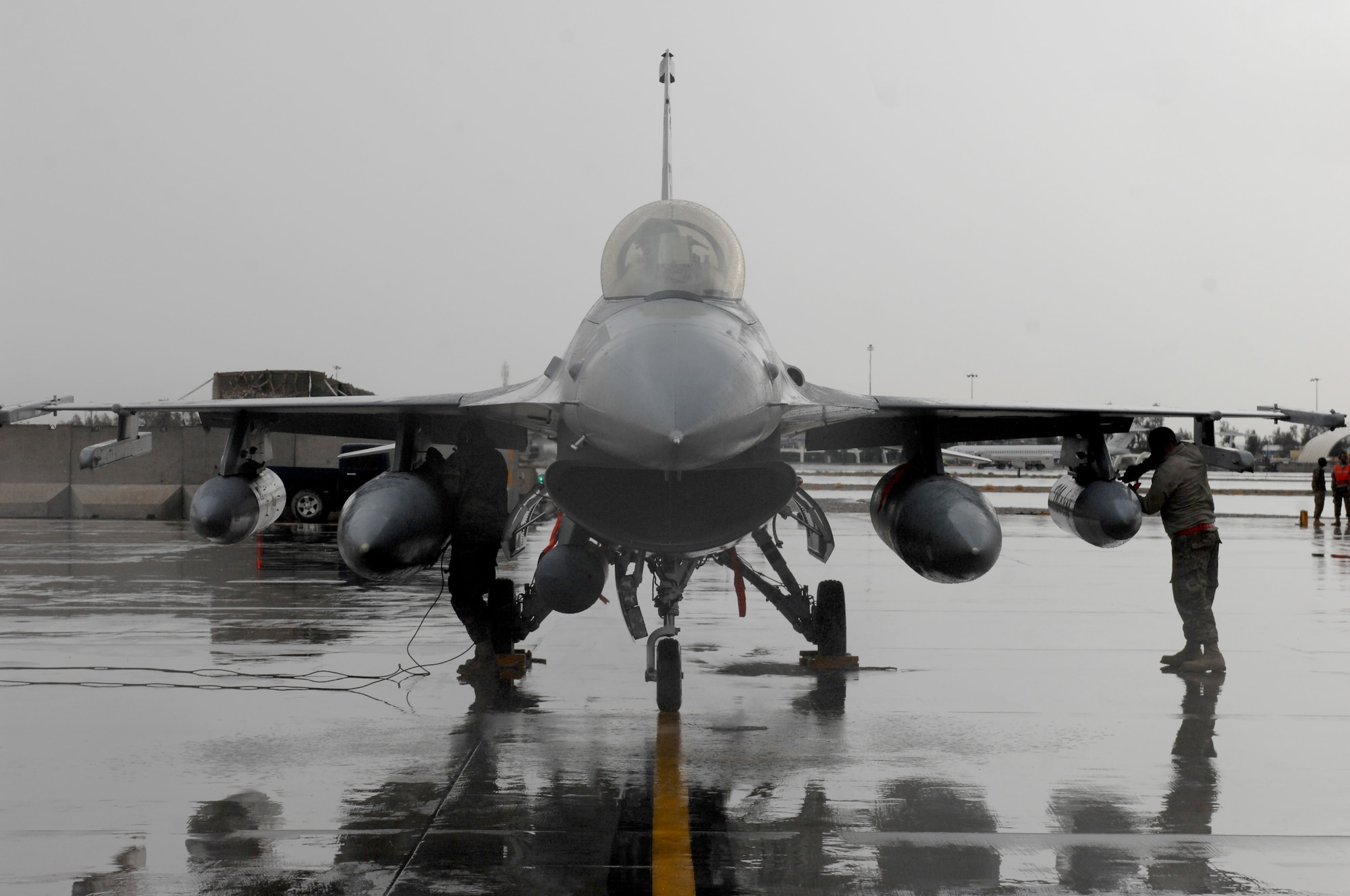 451st Expeditionary Aircraft Maintenance Squadron crewchiefs secure an F-16 Fighting Falcon at Kandahar Airfield, Afghanistan, Nov. 5, 2013. F-16s arrived as a changeover between the 138th Fighter Squadron, Tulsa, Okla. and the 457th Fighter Squadron, Carswell, Texas. (U.S. Air Force photo by Senior Airman Jack Sanders)