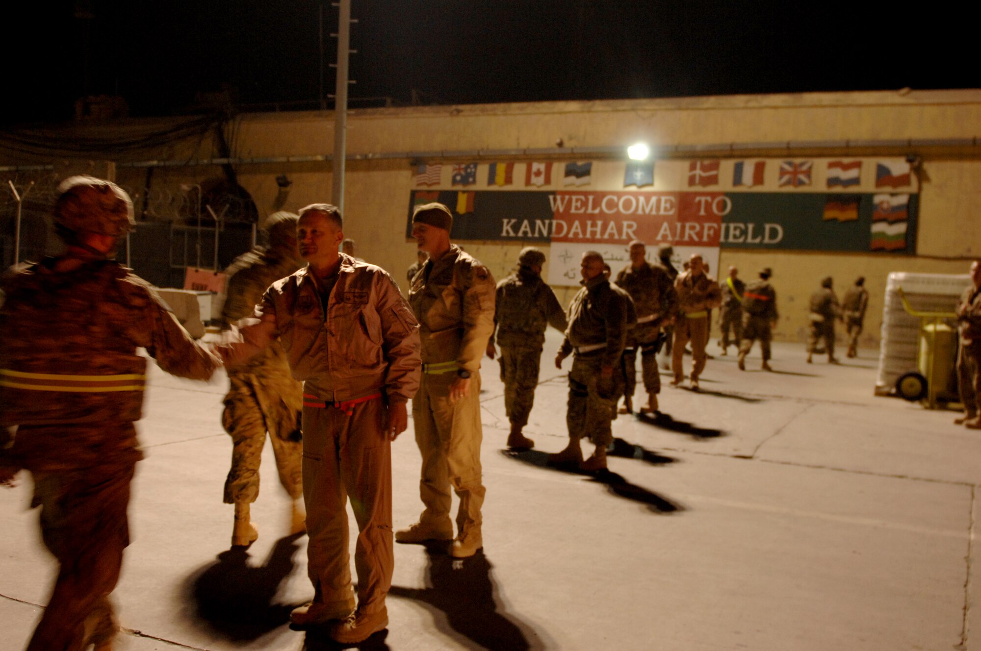 Leadership from the 451st Expeditionary Aircraft Maintenance Squadron greets new arrivals at the inbound passenger terminal Nov. 1, 2013, at Kandahar Airfield, Afghanistan. (U.S. Air Force pho to by Senior Airman Jack Sanders) 