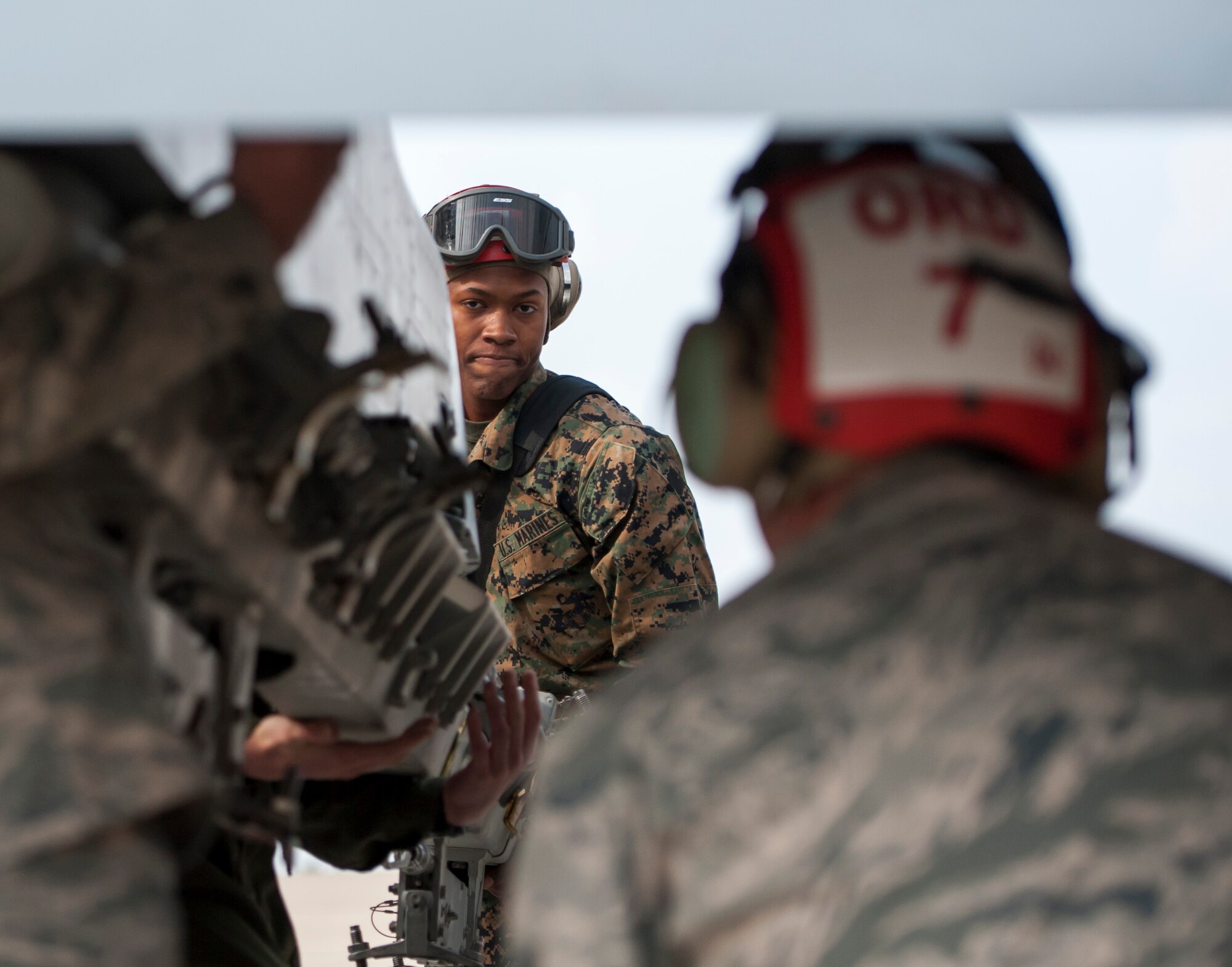 Lance Cpl. Antonio Benton, Marine Fighter Attack Squadron 232, helps instruct Airmen on Marine Corps loading procedures at Kunsan Air Base, Republic of Korea, Nov. 4, 2013. The 8th Maintenance Squadron munitions systems section builds and maintains missiles and bombs in support of the Marine Corps ordnance technicians during Max Thunder. The Airmen partook in the Marine mission and are just one of several teams working side-by-side during the exercise. (U.S. Air Force photo by Senior Airman Armando A. Schwier-Morales/Released) 