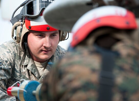 Airman 1st Class Trent Pedersen, 8th Maintenance Squadron munitions systems apprentice, helps Marine Corps ordnance technicians load a missile at Kunsan Air Base, Republic of Korea, Nov. 4, 2013. The 8th Maintenance Squadron munitions systems section builds and maintains missiles and bombs in support of the Marine Corps ordnance technicians during Max Thunder. The Airmen partook in the Marine mission and are just one of several teams working side-by-side during the exercise. (U.S. Air Force photo by Senior Airman Armando A. Schwier-Morales/Released) 