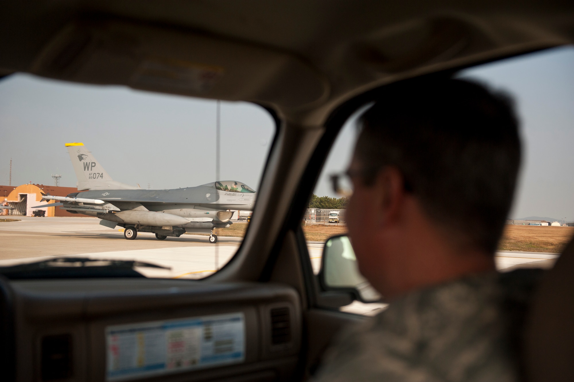 Master Sgt. Billy Swartzel, 8th Fighter Wing weapons safety manager, views a taxiing F-16 Fighting Falcon after it completed a Max Thunder sortie at Kunsan Air Base, Republic of Korea, Nov. 4, 2013. Wing safety staff worked side-by-side with Marine Corps counterparts to ensure not only a successful exercise, but a safe one. Max Thunder exercises foster bilateral aerial training between the Korea Air Power Team, which includes the U.S. Air Force, Marine Corps and the Republic of Korea air force. (U.S. Air Force photo by Senior Airman Armando A. Schwier-Morales/Released)