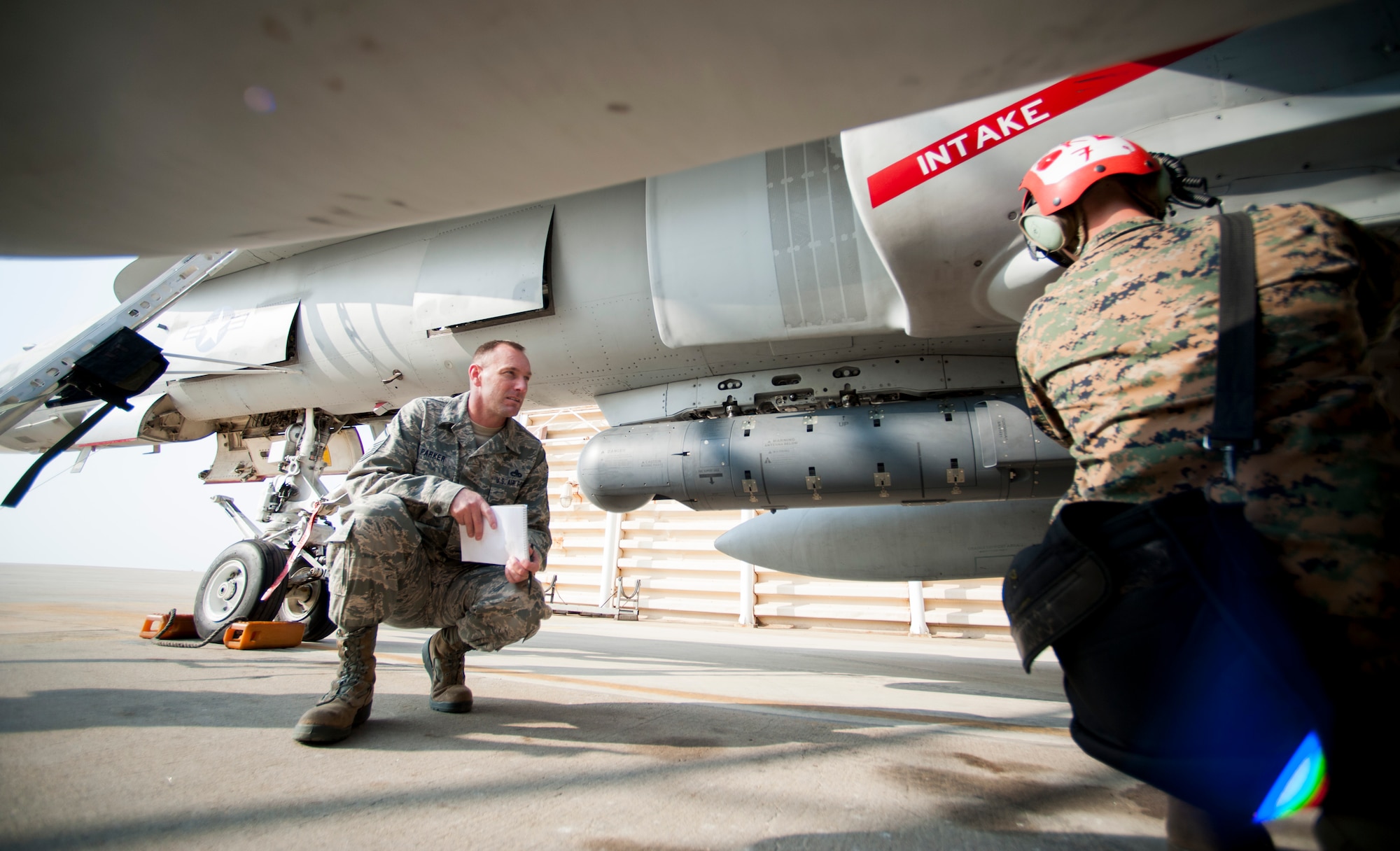 Master Sgt. Chad Parker, 8th Fighter Wing weapons safety manager, ensures a safe installation of defensive measures on a U.S. Marine Corps F-18 Hornet prior to flying a Max Thunder sortie at Kunsan Air Base, Republic of Korea, Nov. 4, 2013. Wing safety staff worked side-by-side with Marine Corps counterparts to ensure not only a successful exercise, but a safe one. Max Thunder exercises foster bilateral aerial training between the Korea Air Power Team, which includes the U.S. Air Force, Marine Corps and the Republic of Korea air force. (U.S. Air Force photo by Senior Airman Armando A. Schwier-Morales/Released)