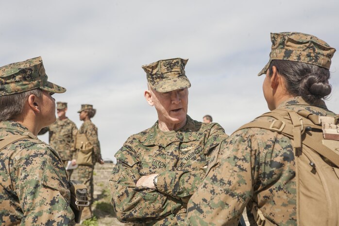 MARINE CORPS BASE CAMP LEJEUNE, N.C. (Nov. 5, 2013) - Lt. Gen Richard T. Tryon speaks with Privates Harlee Bradford (left) and Itzel Milan about their motivations to undergo infantry training. The two privates volunteered to undergo infantry training as a test bed directed by The Commandant of the Marine Corps. After the training, the female Marines will go on to their military occupational specialty schools just like the Marines who attended Marine Combat Training. Though the Marines won’t be infantrymen after their training, they are still proud to be a part of the first women to undergo the training.“To be the first at anything is motivating,” said Milan.