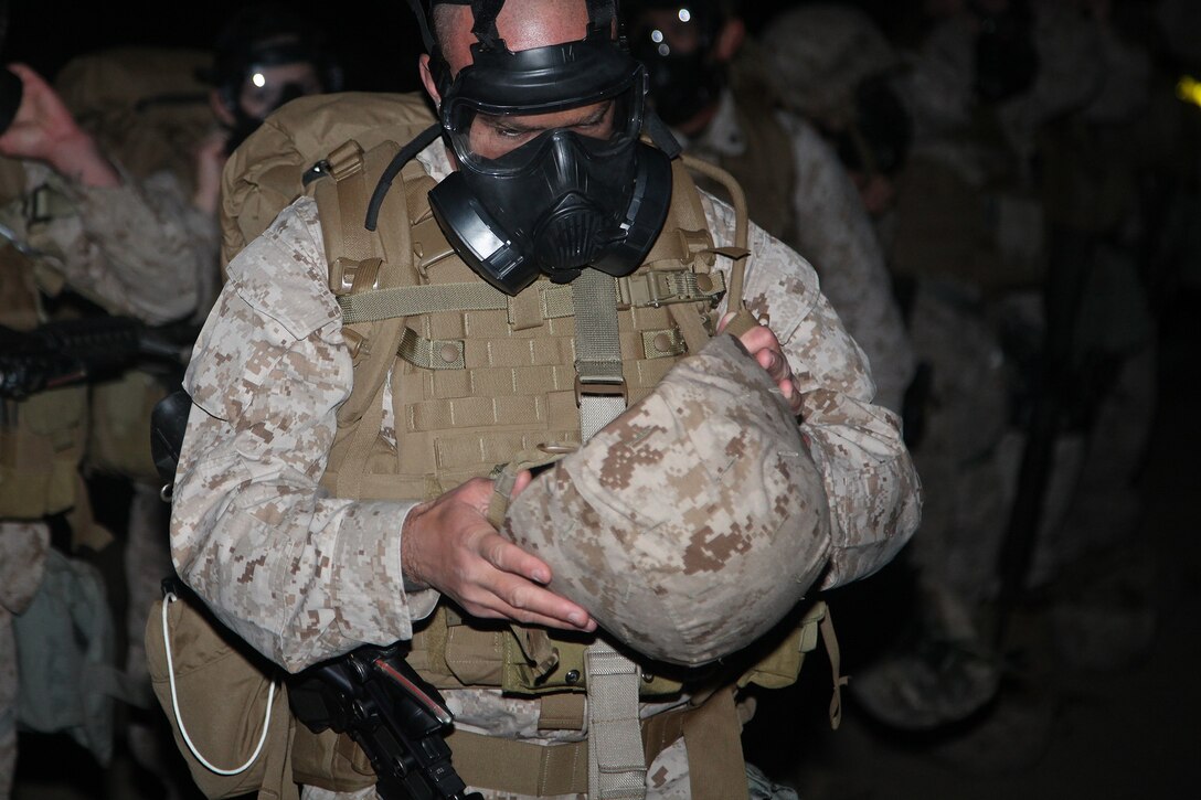 A Marine with Combat Logistics Battalion 15, Combat Logistics Regiment 17, 1st Marine Logistics Group, adjusts his Kevlar during a combat conditioning exercise aboard Camp Pendleton, Calif., Oct. 31, 2013. Marines undergo conditioning exercises, such as hiking, to build physical endurance and camaraderie within the battalion and set Marines up for success if they are faced with situations that requiring physical courage. (U.S. Marine Corps photo by Lance Cpl. Cody Haas/ Released)