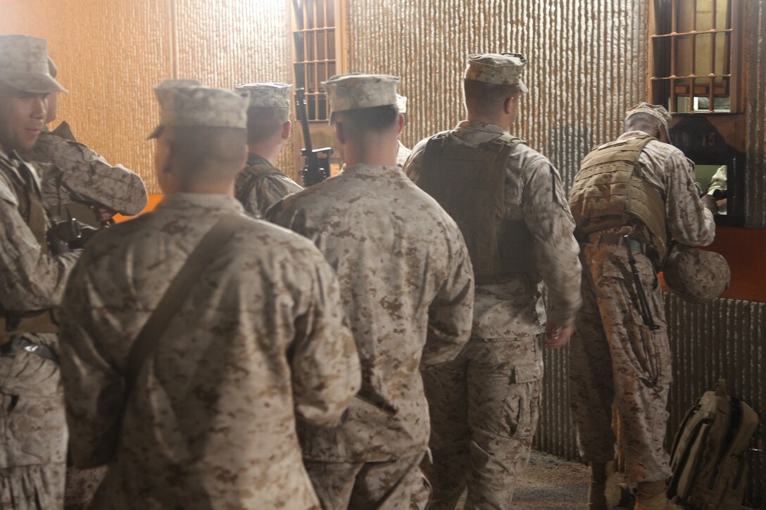 Marines with Combat Logistics Battalion 15, Combat Logistics Regiment 17, 1st Marine Logistics Group, draw their weapons before conducting a combat conditioning exercise aboard Camp Pendleton, Calif., Oct. 31, 2013. Marines undergo conditioning exercises, such as hiking, to build physical endurance and camaraderie within the battalion and set Marines up for success if they are faced with situations requiring physical courage.