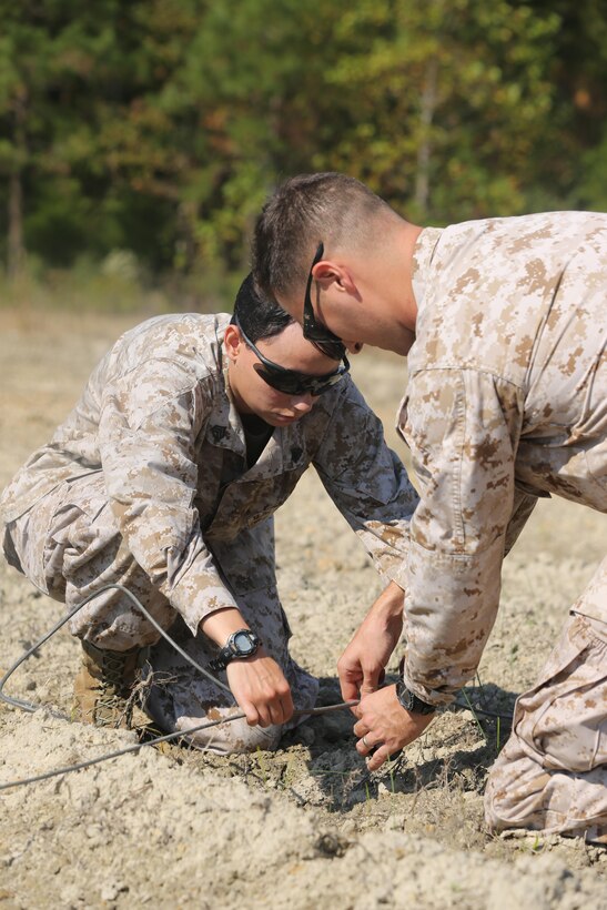 Sgt. Johazais K. Wyble, left, and Gunnery Sgt. Bernard J. Coyne plant an explosive in the ground at the Explosive Ordnance Disposal range Oct. 30. Wyble was one of two Marines selected to participate in the Commander’s Incentive Program, a program made to award exemplary Marines. Coyne is an EOD technician.


