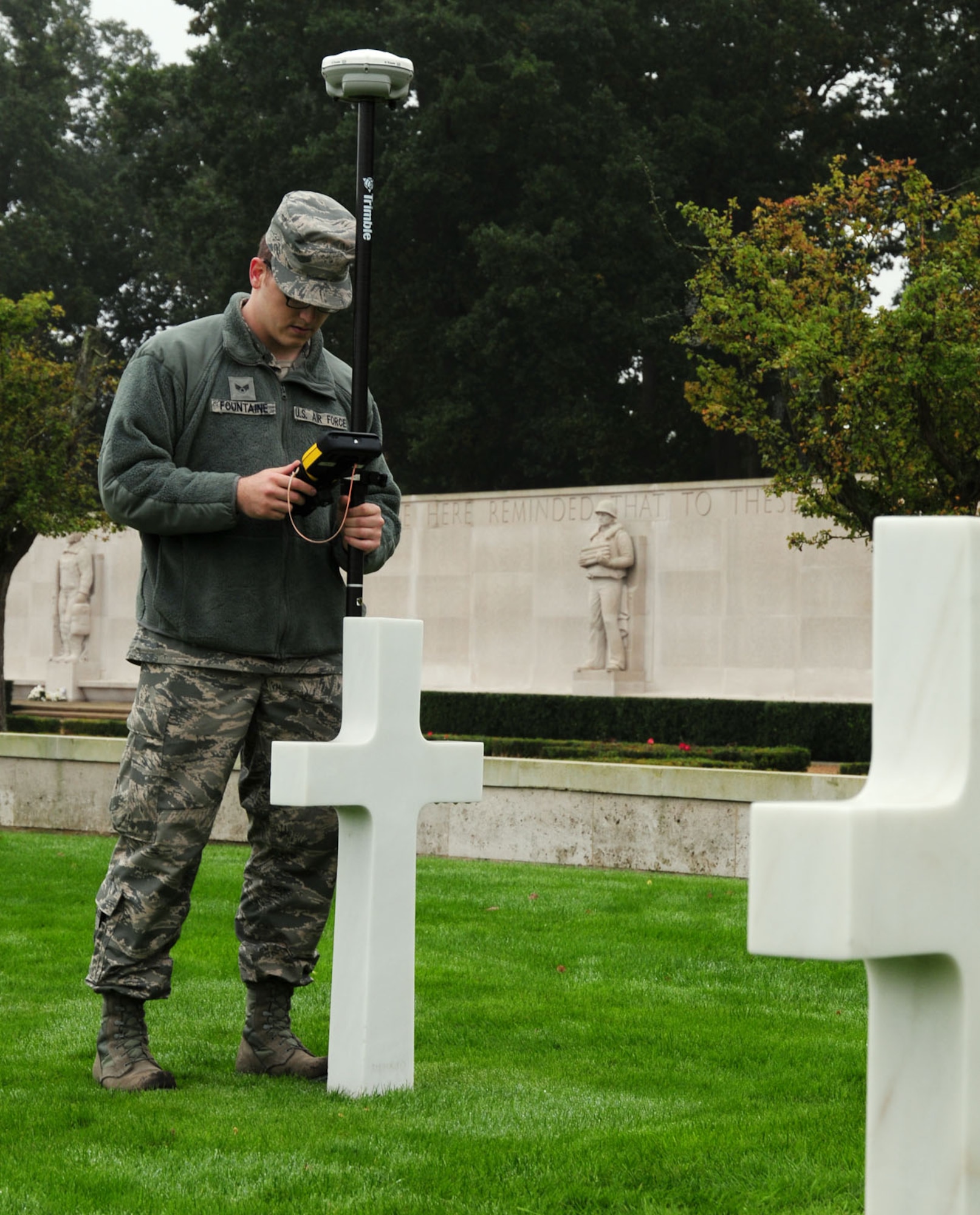 Senior Airman Logan Fountaine uses GPS base equipment Oct. 16, 2013, to determine grid coordinates and measure latitude, longitude and elevation of headstones at Madingley American Cemetery, near Cambridge, England. Airmen from the 100th CES engineering flight were taking GPS readings to annotate the exact location of each individual headstone. All the data from the project will be used to create an electronic map that allows families and friends of those Americans lost in World War II to pinpoint the location of their resting place. Fountaine is a 100th Civil Engineer Squadron engineering flight journeyman.