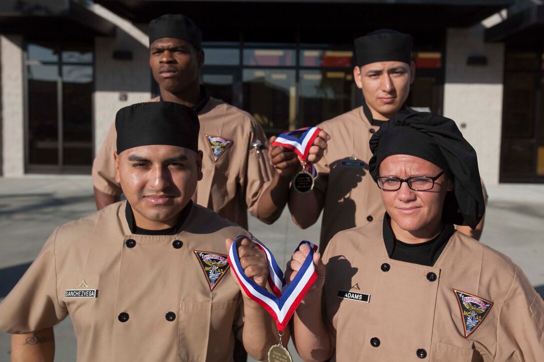 (Clockwise from top left) Pfc. Devon Jackson, Cpl. Elias Gonzalez, Lance Cpl. Kelly Adams, Lance Cpl. Ferman Sanchez-Vega, all food service specialists aboard Marine Corps Air Station Beaufort, won first and third place in the Chef Team of the Quarter competition aboard Marine Corps Recruit Depot Parris Island, Oct. 25. Adams and Sanchez-Vega will compete again in the Chef Team of the Year competition against other winning teams.