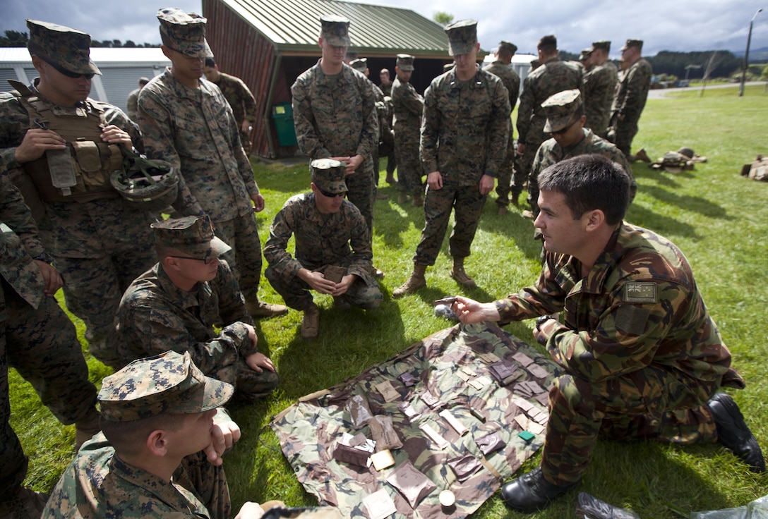 Flt. Lt. Dan McCormack, reconnaissance platoon, 1 Royal New Zealand Infantry Regiment, New Zealand Defence Force, from Palmerston North, New Zealand, shows U.S. Marines the contents and cooking methods of the New Zealand Operational Ration Pack during the initial stages of exercise Southern Katipo 2013 at Linton Military Camp in Linton, New Zealand, Nov. 4. The purpose of SK13 strengthens military to military relationships and cooperation with partner nations and the New Zealand Defence Force.