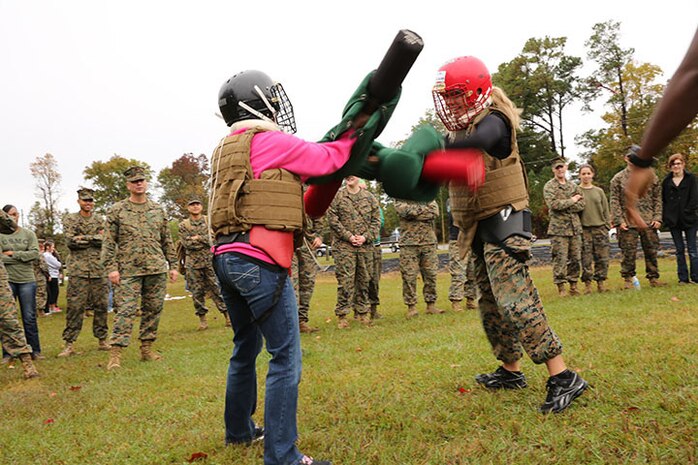 Spouses of Marines with 2nd Supply Battalion, Combat Logistics Regiment 25, 2nd Marine Logistics Group use pugil sticks during a Marine Corps Martial Arts Program session during a Jane Wayne Day aboard Camp Lejeune, N.C., Nov. 7, 2013. Husbands and wives of the battalion participated in a variety of activities to give them a chance to better understand what their loved ones go through in the Marine Corps.  (U.S. Marine Corps photo by Lance Cpl. Shawn Valosin)