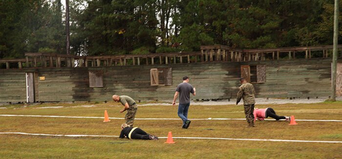 Marines with 2nd Supply Battalion, Combat Logistics Regiment 25, 2nd Marine Logistics Group cheer their wives on during the combat fitness test portion of a Jane Wayne Day held aboard Camp Lejeune, N.C., Nov. 7, 2013. Jane Wayne Day gave spouses a better understanding of the physical challenges their loved ones have experienced as Marines. (U.S. Marine Corps photo by Lance Cpl. Shawn Valosin)