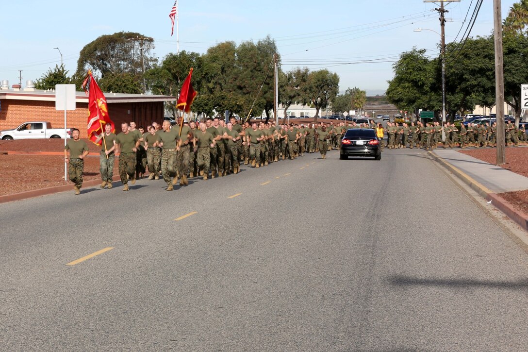 Brigadier Gen. Daniel Yoo, left, commanding general, I Marine Expeditionary Force (Forward), leads I MEF (Fwd) Marines and sailors on a motivational run in celebration of the 238th Marine Corps Birthday aboard Camp Pendleton, Calif., Nov. 7, 2013. The command, which is scheduled to deploy to Helmand province, Afghanistan, during early 2014, took time out of their predeployment training to celebrate the Marine Corps' upcoming birthday by conducting the run and a cake-cutting ceremony.