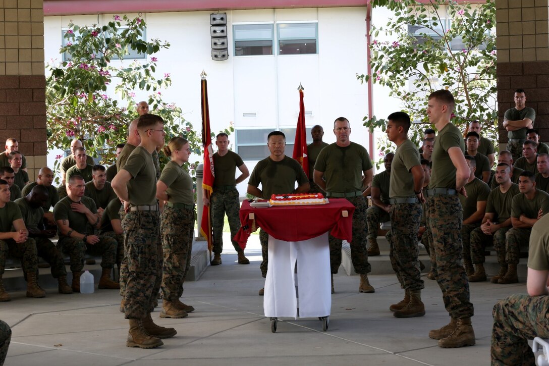 Brigadier Gen. Daniel Yoo, center, commanding general, I Marine Expeditionary Force (Forward), and Sgt. Maj. Douglas Berry, center right, sergeant major, I MEF (Fwd), stand at parade rest during I MEF (Fwd)'s cake-cutting ceremony aboard Camp Pendleton, Calif., Nov. 7, 2013. The command, which is scheduled to deploy to Helmand province, Afghanistan, during early 2014, took time out of their predeployment training to celebrate the Marine Corps' upcoming birthday by conducting a motivational run and the cake-cutting ceremony.
