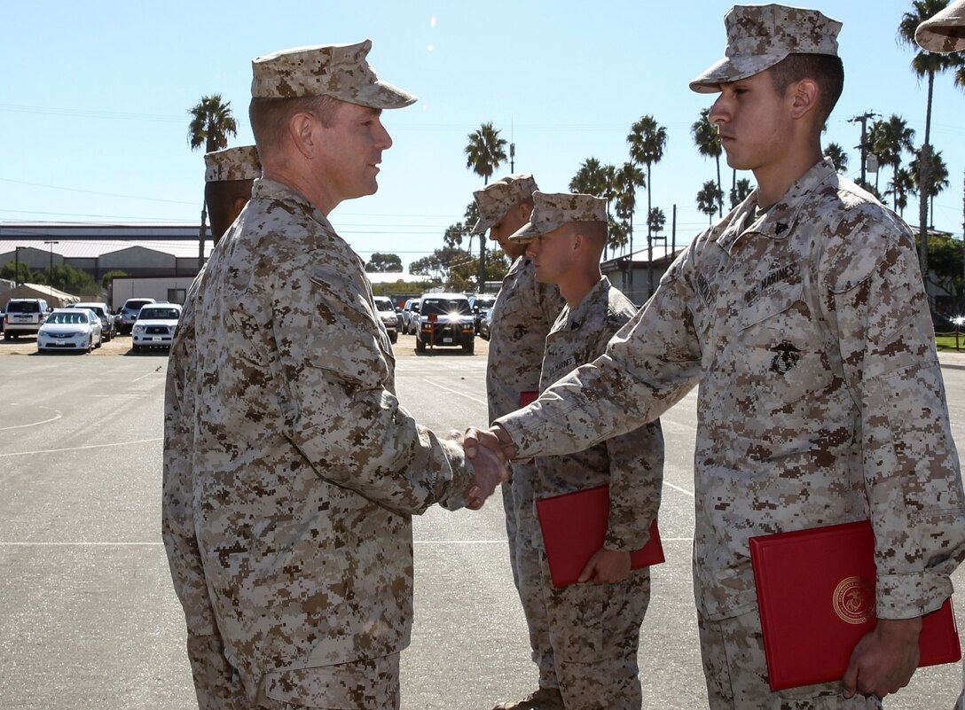 Lieutenant Col. John R. O'Neal, commanding officer, 15th Marine Expeditionary Unit, congratulates Cpl. Rene Gonzalez, data network specialist, 15th MEU, on his promotion to corporal during a promotion ceremony held on the Camp Del Mar Parade Deck aboard Camp Pendleton, Calif., Nov. 1. Gonzalez, 21, is from Chicago. (U.S. Marine Corps photo by Cpl. Emmanuel Ramos/Released)