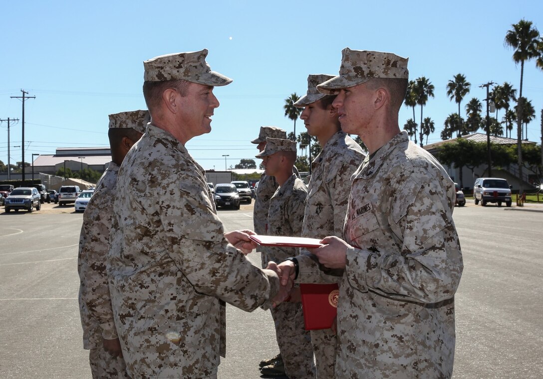 Lieutenant Col. John R. O'Neal, commanding officer, 15th Marine Expeditionary Unit, congratulates Lance Cpl. Michael Richardson, intelligence analyst, 15th MEU, on his promotion to lance corporal during a promotion ceremony held on the Camp Del Mar Parade Deck aboard Camp Pendleton, Calif., Nov. 1. Richardson, 19, is from Riverside, Calif. (U.S. Marine Corps photo by Cpl. Emmanuel Ramos/Released)