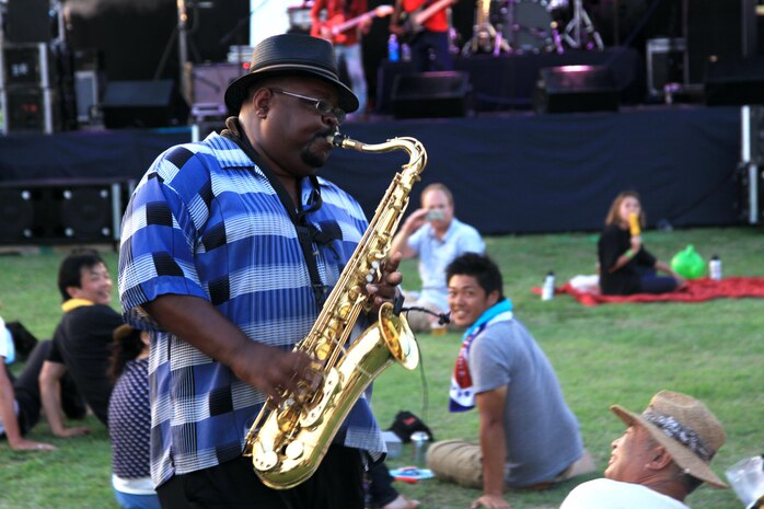 Walter Gentry, Johnny “V” Vernaza saxophone player, strolls around the audience while performing a melodic jazz solo during the Summer Music Festival Open House at the Torii Pines Golf Course here Saturday.