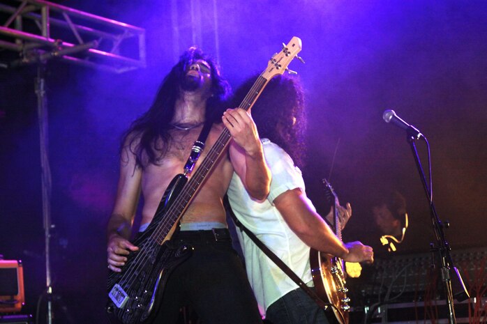 Lani Abe (left), Airiel Down bass player, and Michael Abe, Airiel Down guitarist, lean back-to-back while jamming to their song “Gorilla” during the Summer Music Festival Open House at the Torii Pines Golf Course here Saturday. Airiel Down was the headline performance for the festival. Other performances included: Ghetto Script, The Iwakuni Elite Tigers, 13s, Blues Workshop, Iwakuni Daiko, Jalopy and Johnny “V” Vernaza.