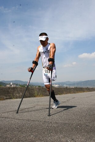 Masafumi Yasul, a triathlon competitor, pushes himself to finish the last running portion of the Marine Corps Community Services Iwakuni Modified Triathlon here Sunday. Yasul lost his leg years ago and continues to compete in triathlons and other races.