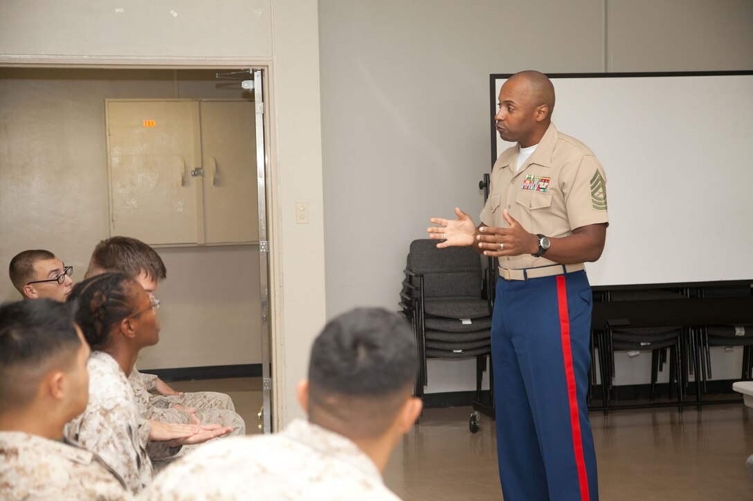 Master Sgt. Leodis Smith speaks to junior Marines at 3rd Medical Battalion's Lance Corporals' Symposium Oct. 30 at the Chapel Center on Camp Foster. The three-day symposium was developed by staff noncommissioned officers within 3rd Med. Bn. to help lance corporals and privates first class develop their leadership styles in preparation for the next rank as well as introducing them to the NCO mindset. Smith is the career planner 3rd Marine Logistics Group, III Marine Expeditionary Force. (U.S. Marine Corps photo by Lance Cpl. Natalie M. Rostran/ Released)