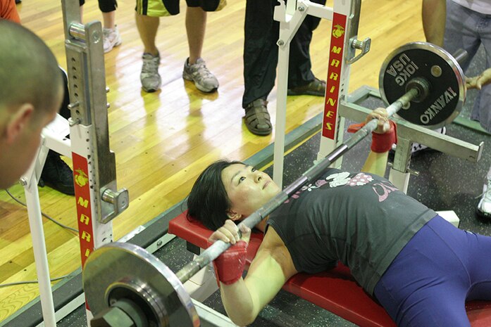 Hiroko Yanai bench presses 99 pounds during the 2011 Summer Slam Open Bench Press Challenge at the IronWorks Gym sports courts here Saturday. Yanai placed second with 105 pounds. Twenty one contestants participated in the challenge.