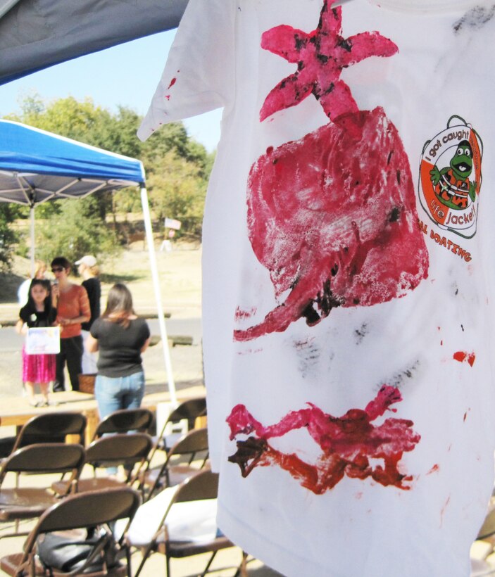 Student visitors to the Corps of Engineers booth made hand-stamped t-shirts decorated with a variety of fresh water and salt water creature shapes. Young fans of the Chinook salmon celebrated the famous fish in drawings, paintings and hand-painted t-shirts during the fifth annual Salmon Festival, Oct. 26, at Stanislaus River Parks, the U.S. Army Corps of Engineers facility in Knights Ferry, Calif. 